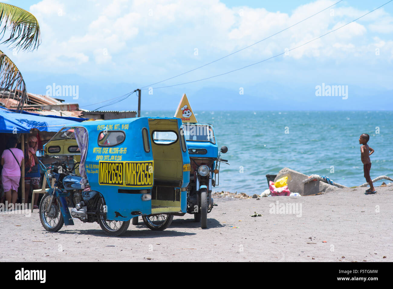 Two cyclos parked at the beach in General Santos City, the southernmost