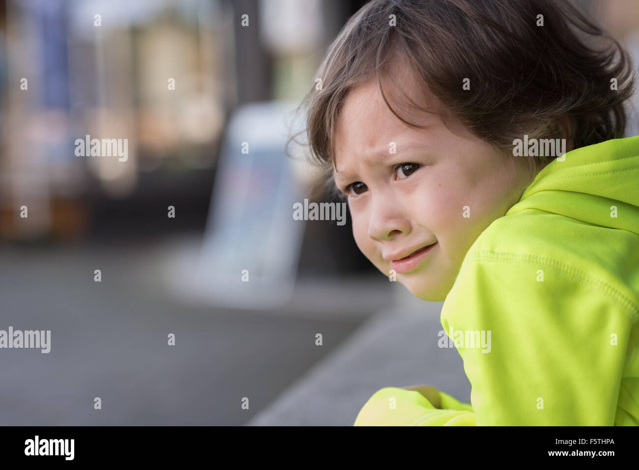 A 3 year old boy with a very upset, stressed expression on his face. Stock Photo