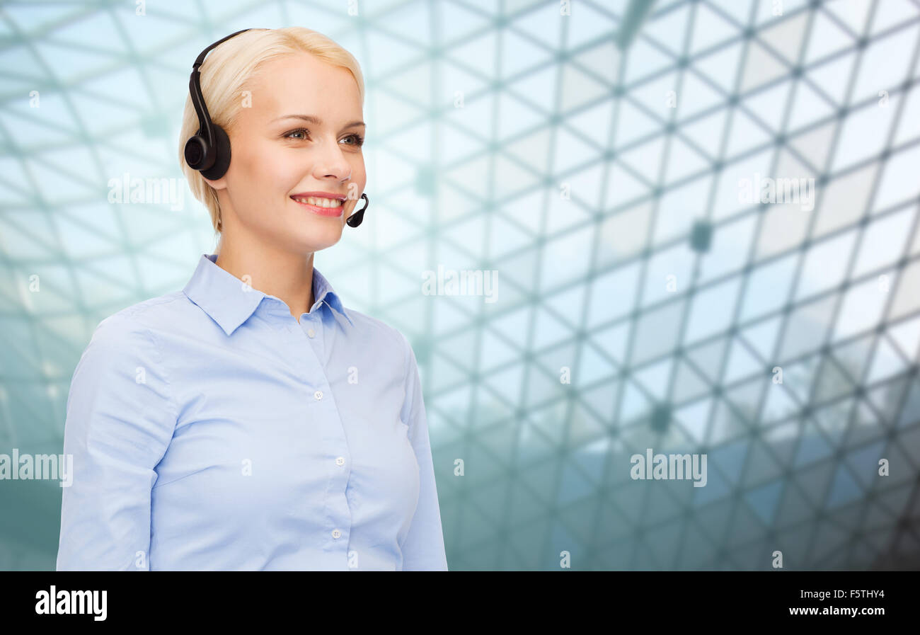 helpline operator in headset over grid background Stock Photo