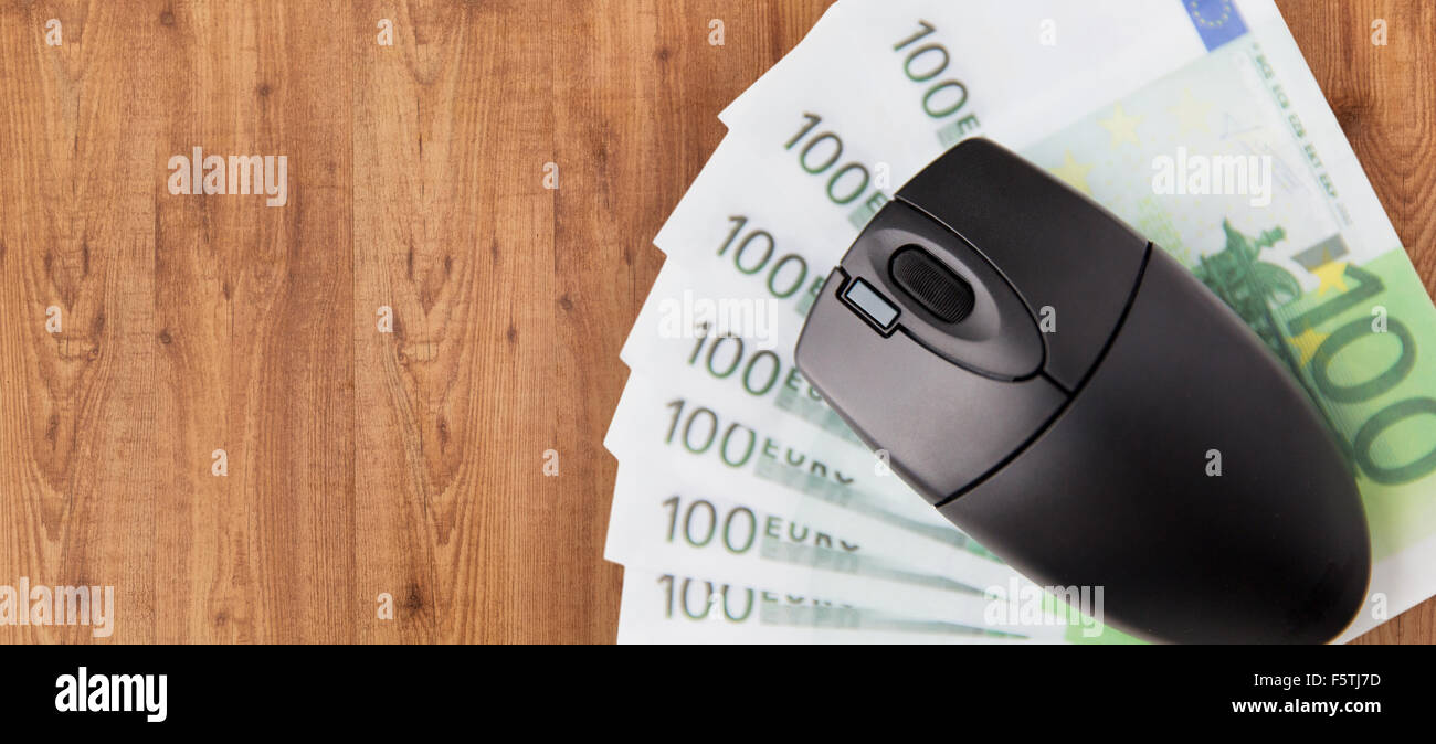 close up of computer mouse and euro money Stock Photo