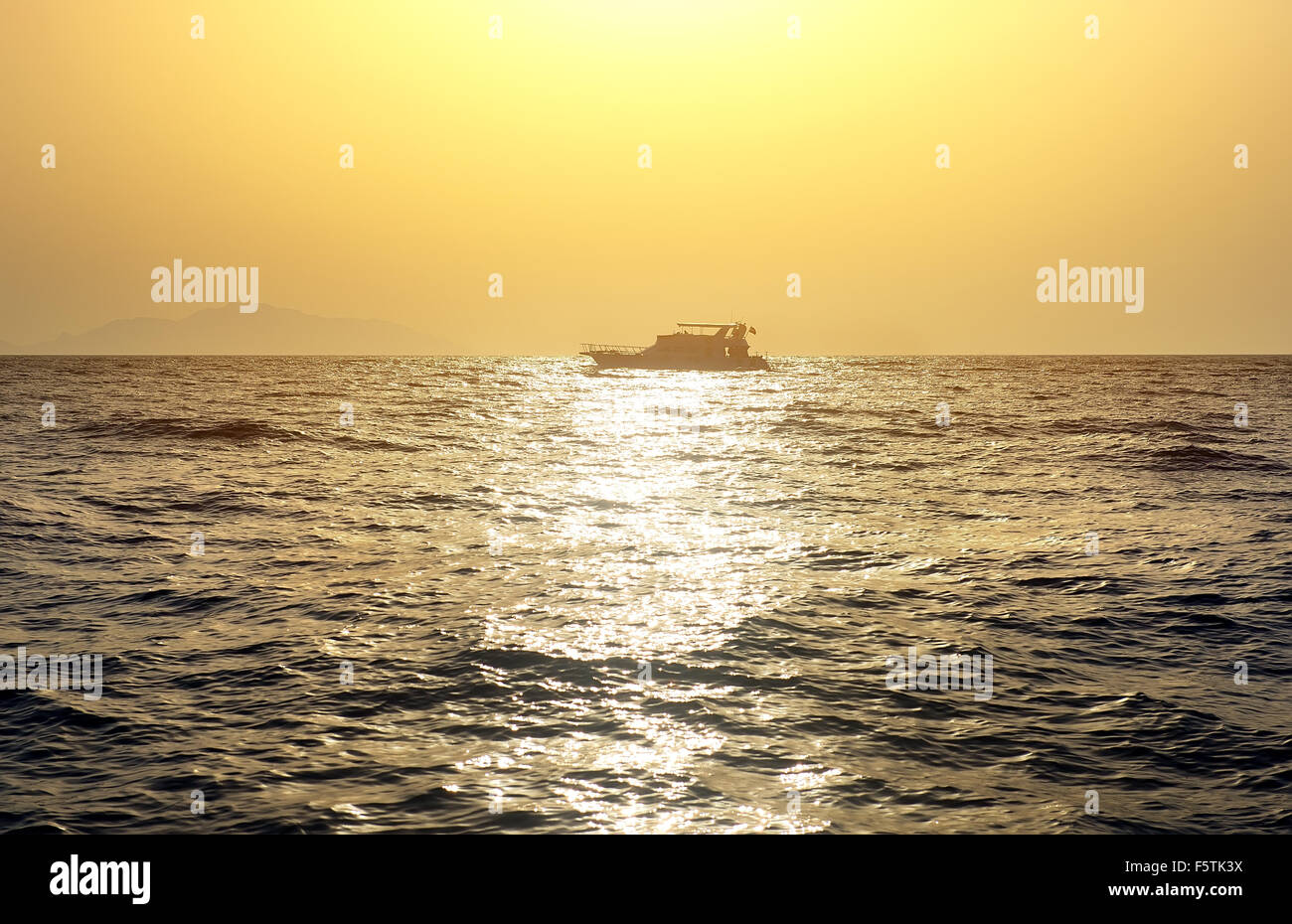 Boat in red sea at the sunset Stock Photo