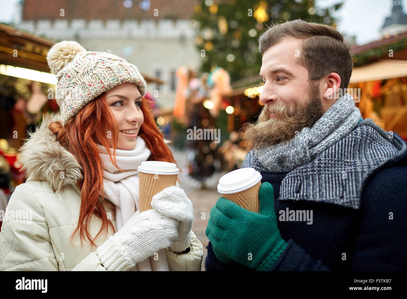 happy couple drinking coffee on old town street Stock Photo
