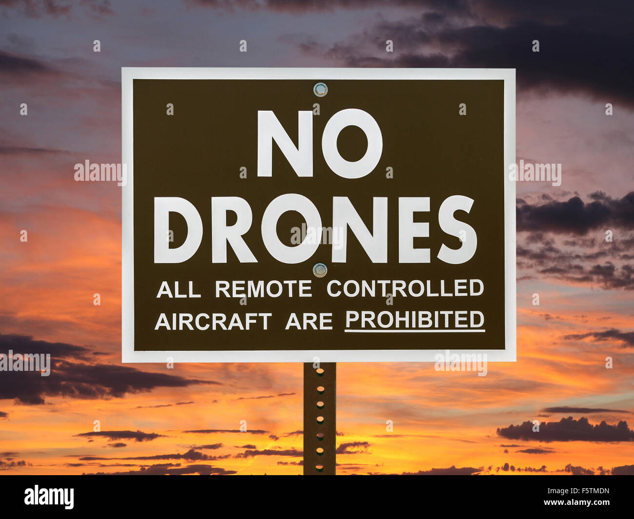 No drones sign with sunset sky. Stock Photo