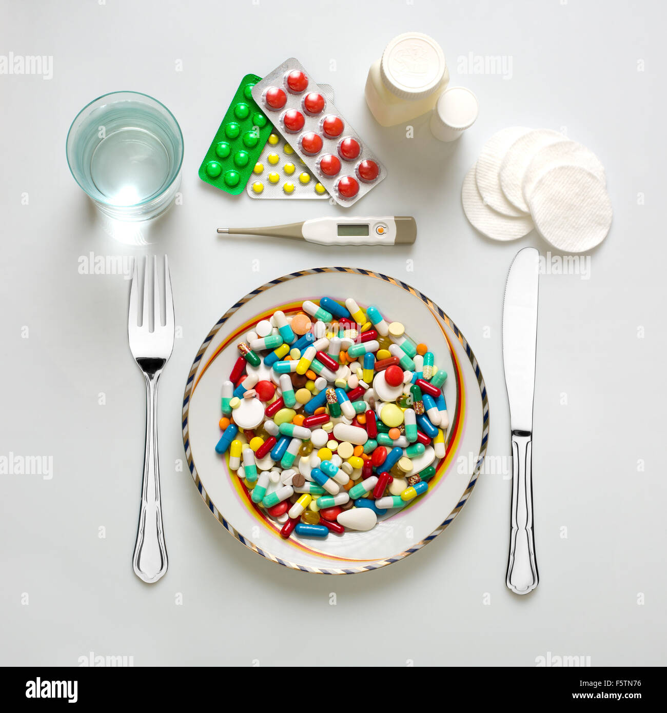 Medical dinner set with silverware and pills Stock Photo Alamy