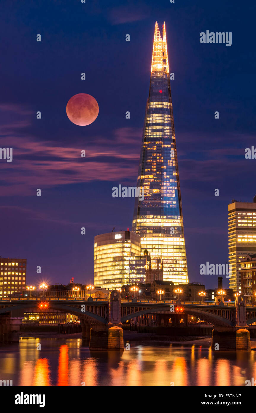The Shard and skyline at night with red moon or blood moon City of London South Bank  southwark London England UK GB  Europe Stock Photo