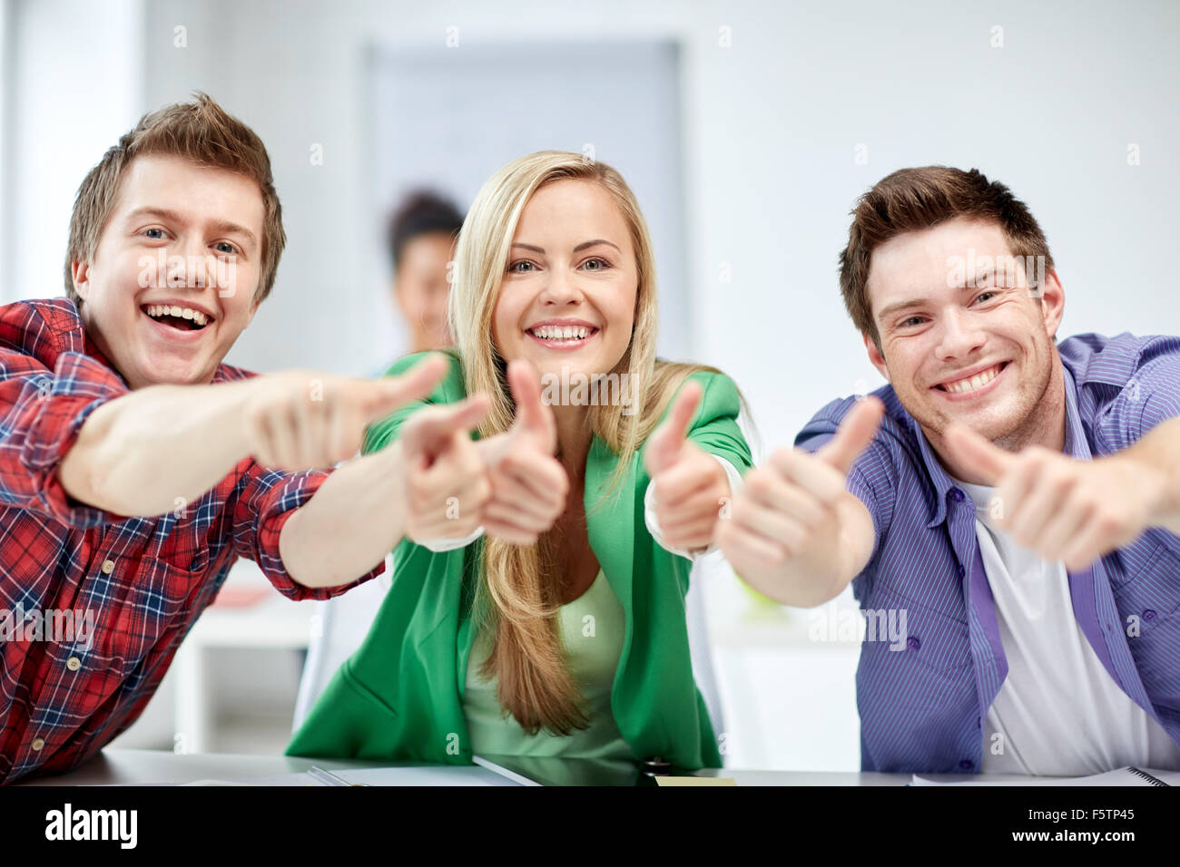 group of happy students showing thumbs up Stock Photo - Alamy