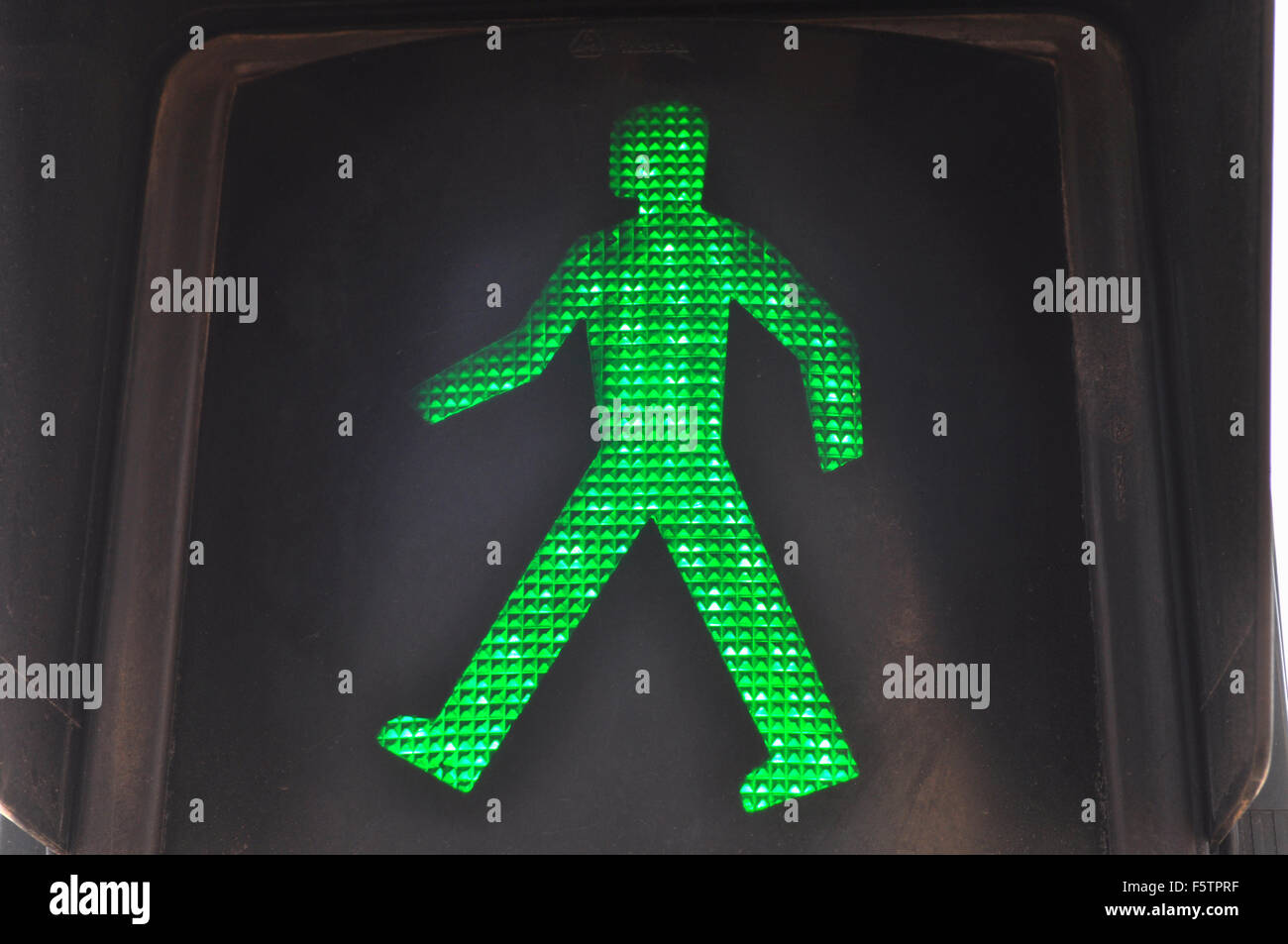 Green man in traffic light, indicating it is safe to walk and cross the road, Spain Stock Photo