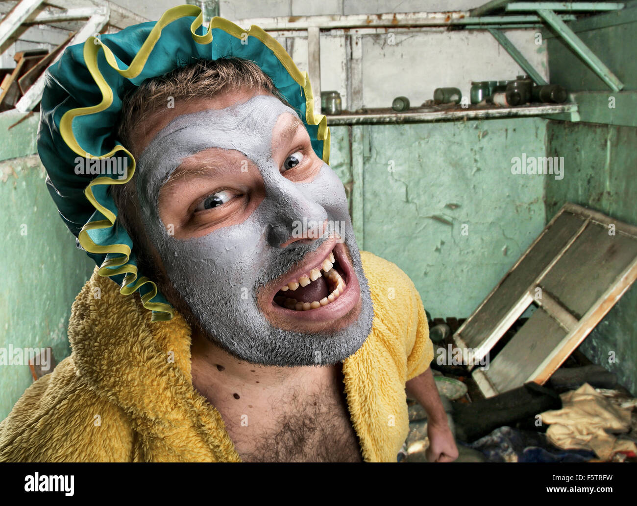 Strange, crazy man with face pack in ruins Stock Photo