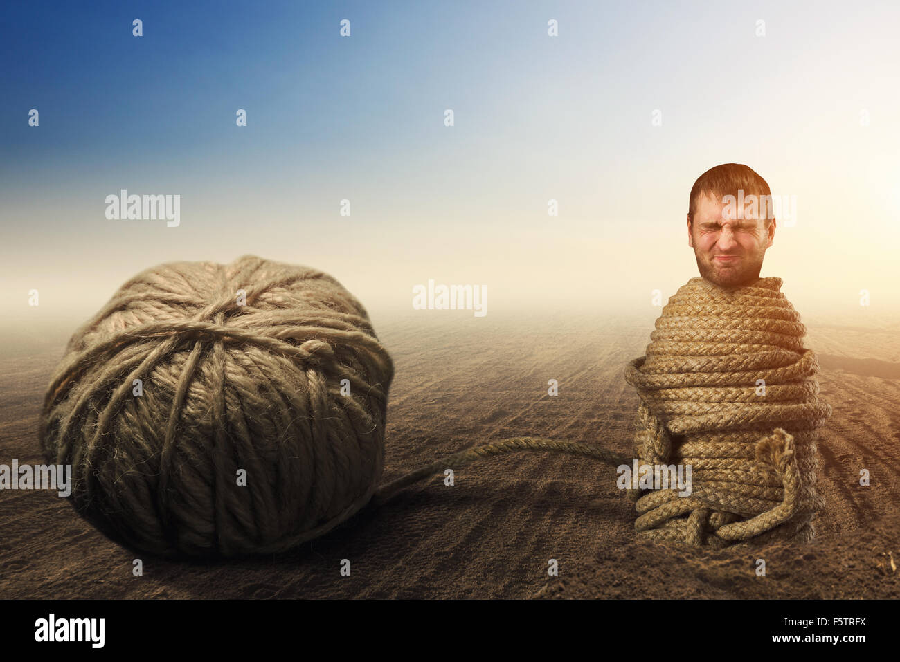 Man in captivity of threads, helplessness concept Stock Photo