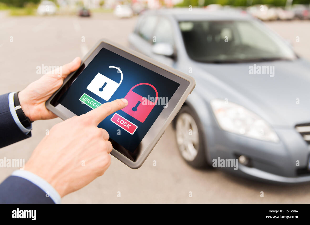 close up of hands with lock icons on tablet pc Stock Photo