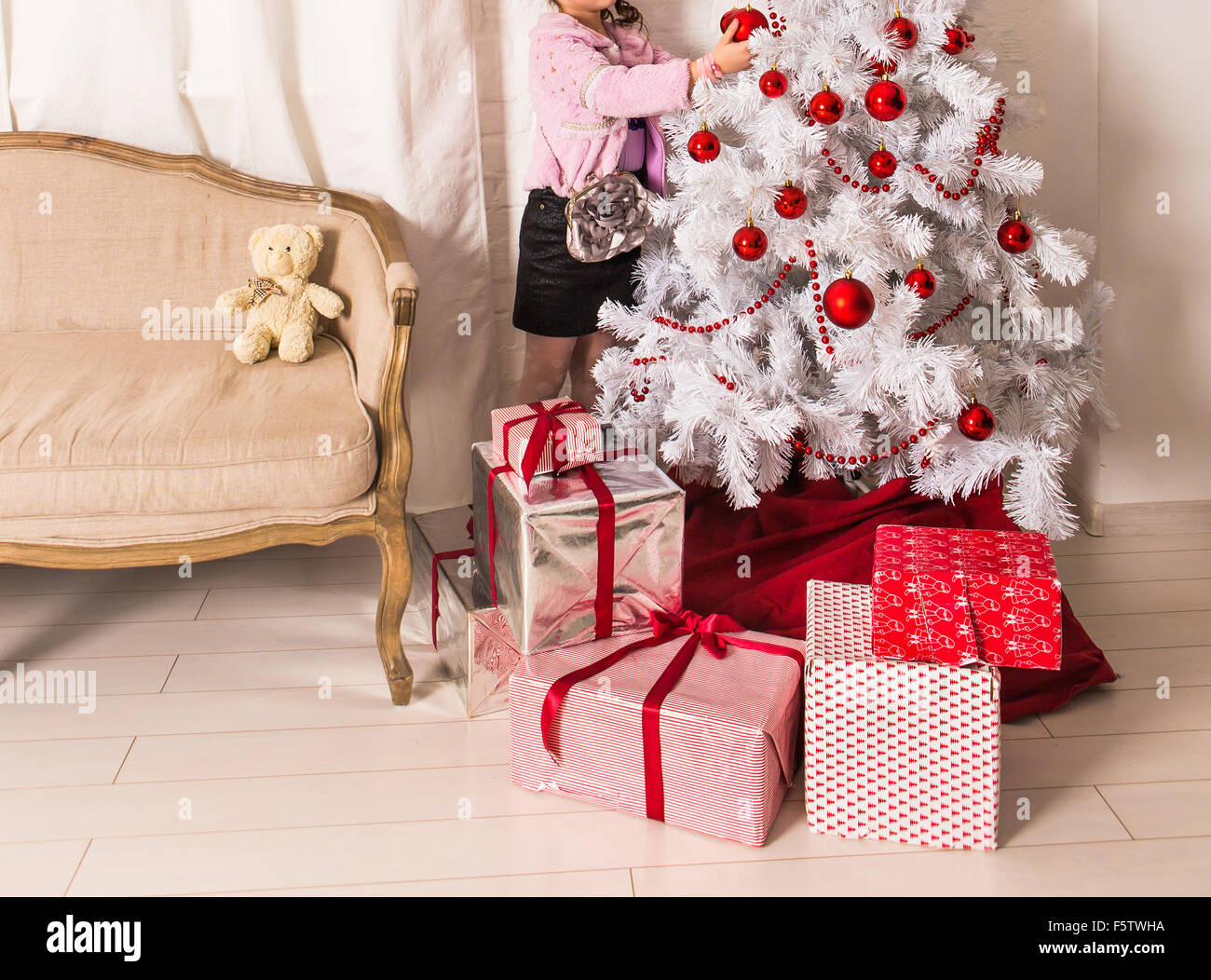 Little girl decorating christmas tree Stock Photo - Alamy