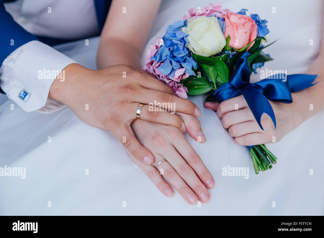 Hands of the bride and groom and wedding bouquet Stock Photo - Alamy