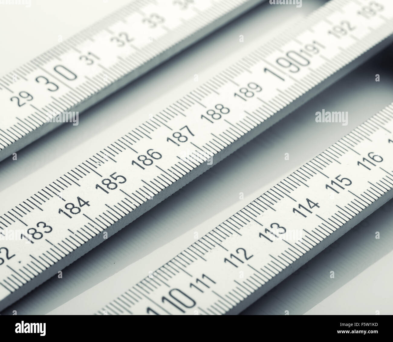 Closeup of white wooden rulers Stock Photo - Alamy
