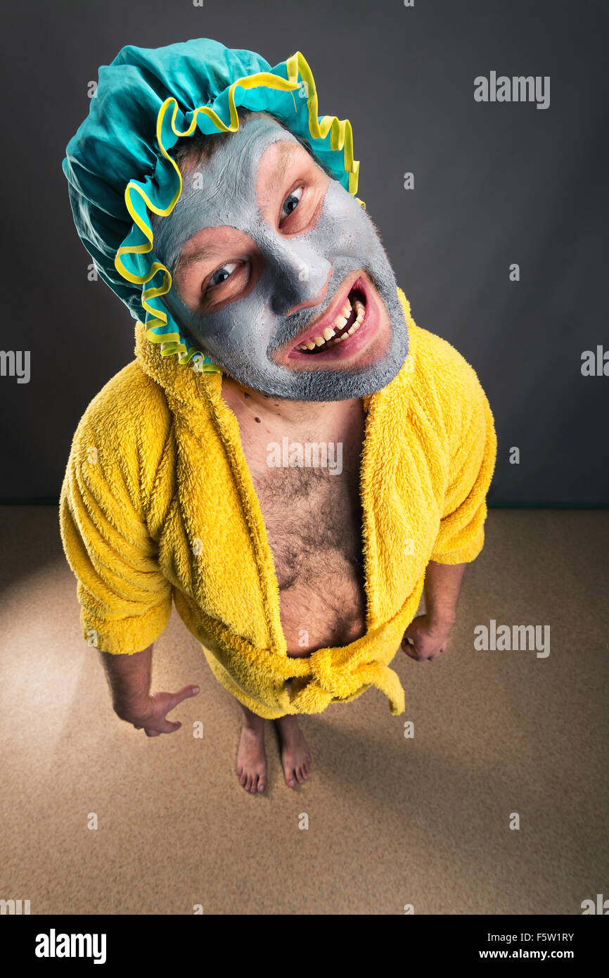 Strange, crazy man with face pack standing in the room Stock Photo