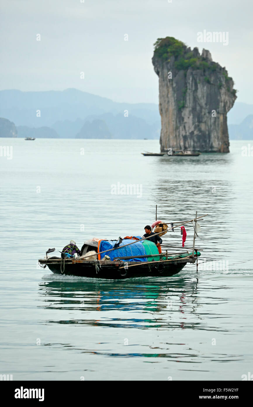 Fishing boat and limestone (karst) tower, Ha Long Bay, Bai Tu Long Sector, near Ha Long, Vietnam Stock Photo