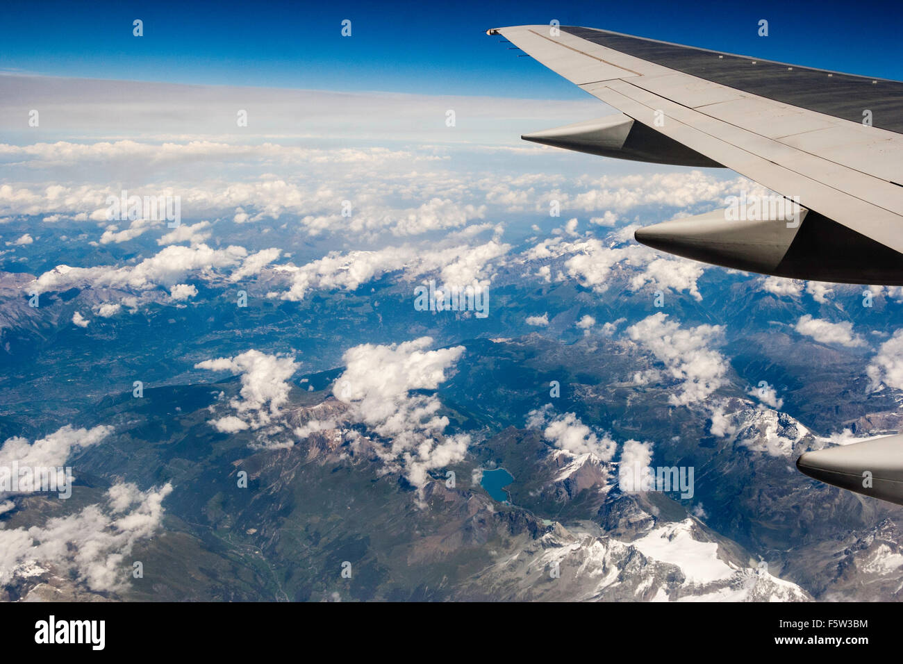Switzerland. The Alps, seen from plane at 30,000 feet. Snow-topped  mountains lakes. Edge of plane wing with flap track fairings Stock Photo -  Alamy