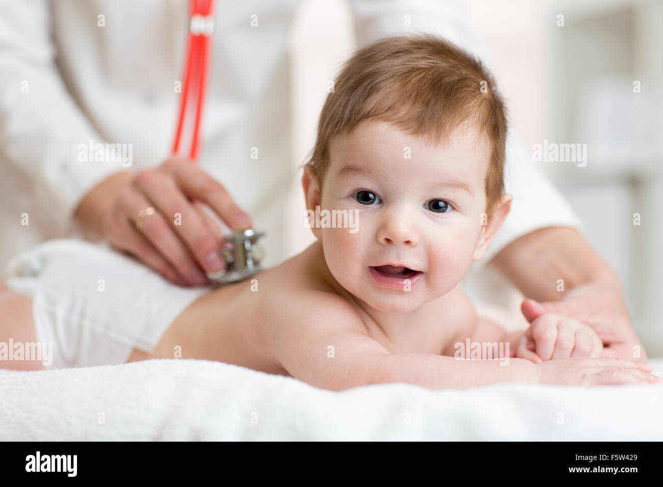 doctor listens to baby heart with stethoscope Stock Photo Alamy