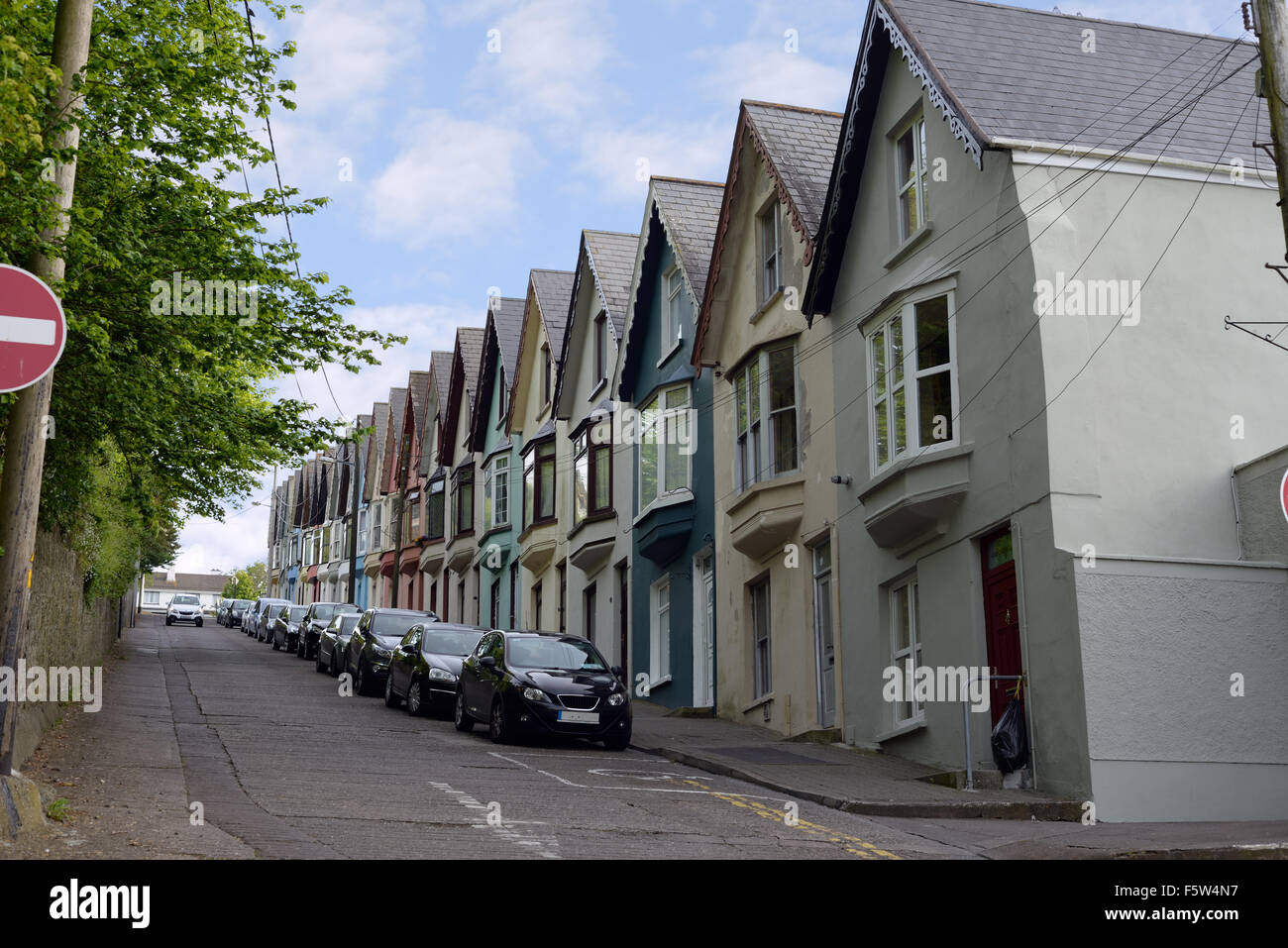 street view of houses on a steep hill in cobh county cork ireland Stock