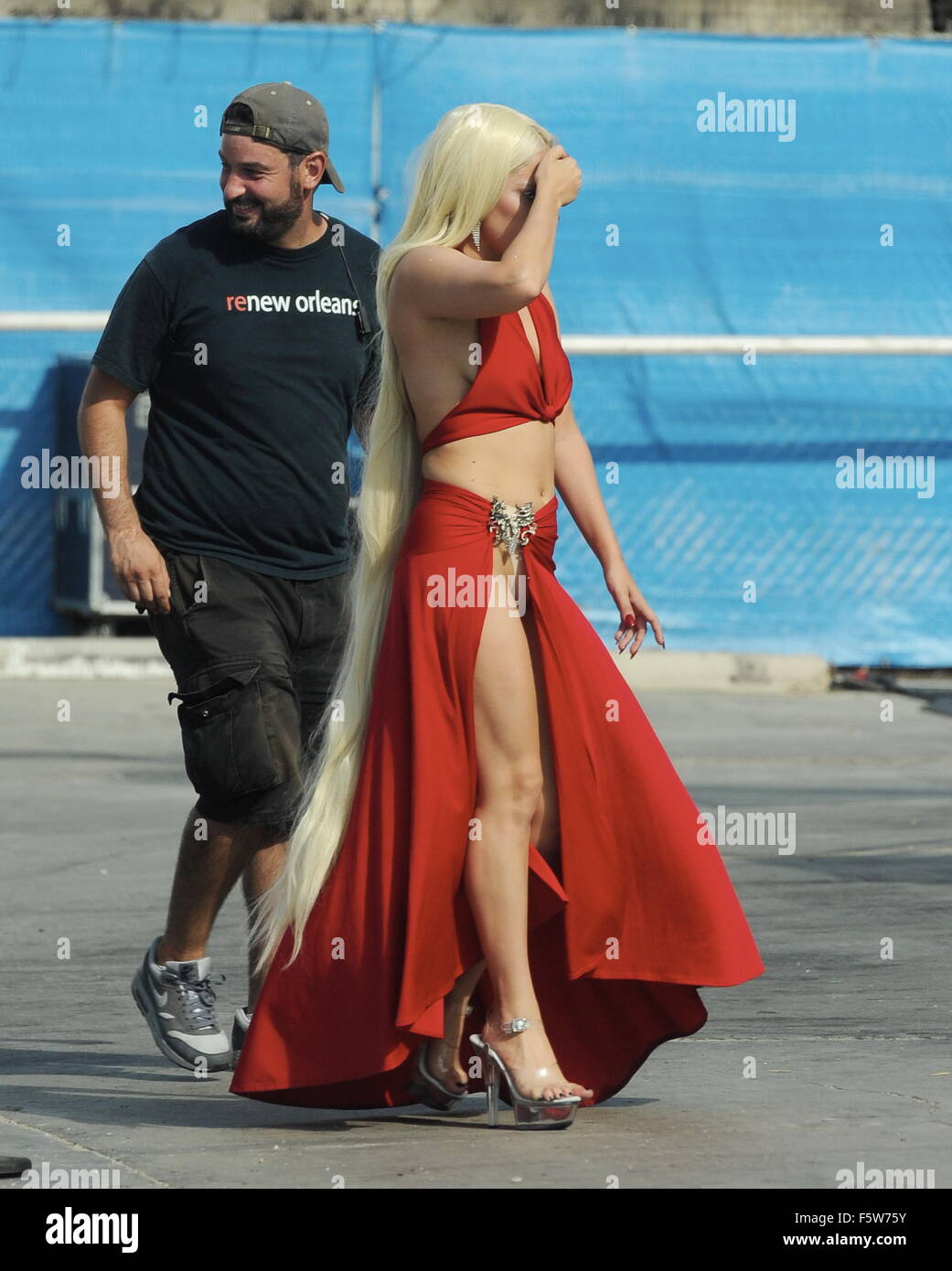 Lady Gaga leaves little to the imagination as she steps out of her trailer  in a red dress with a long slit that showed off her toned legs for a scene  in "