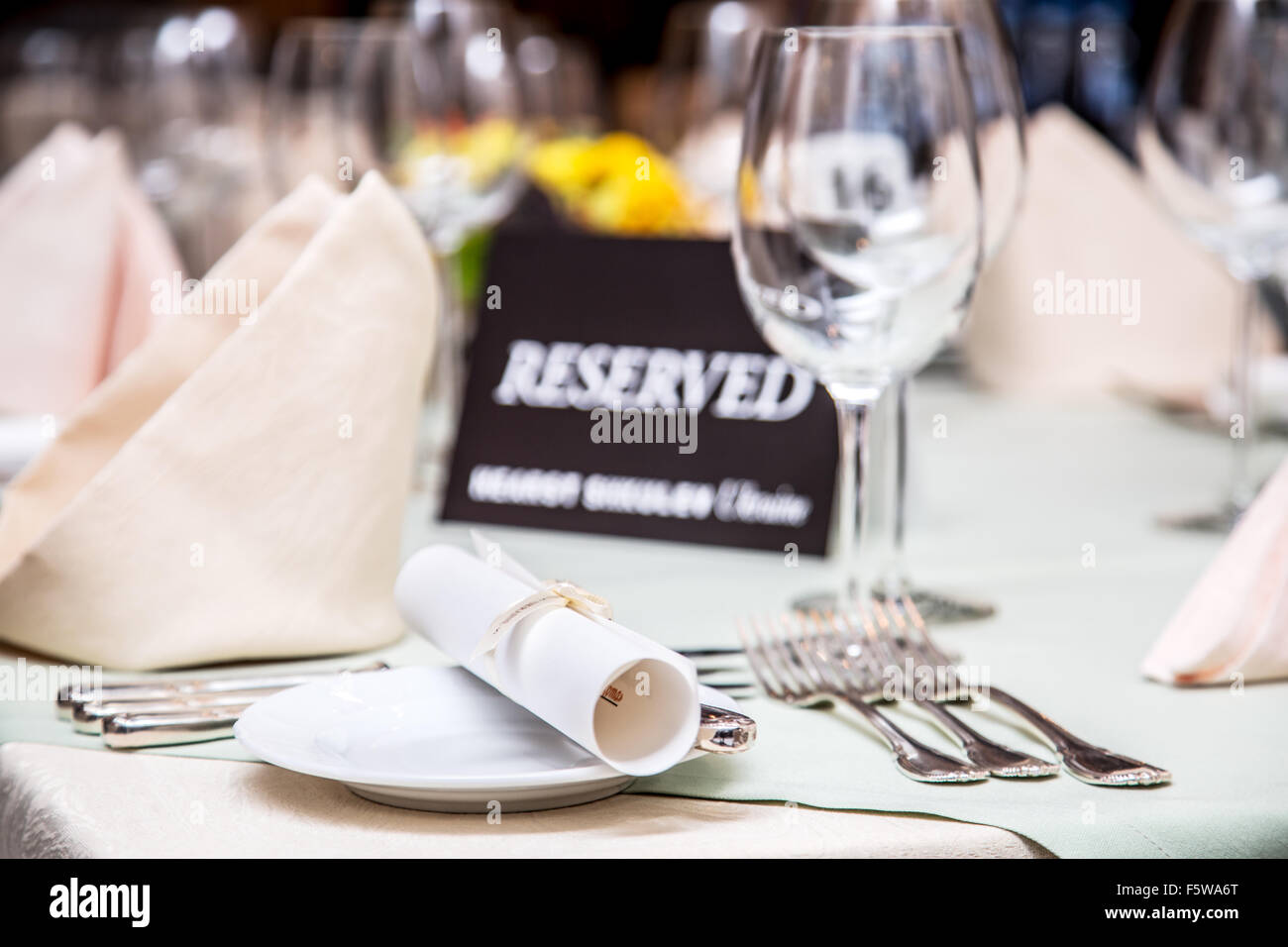 Festival dinner setting and 'Reserved' sign. Stock Photo