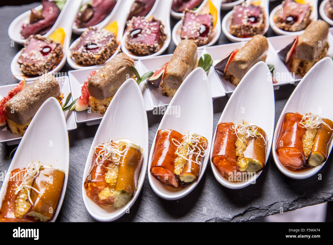 Gourmet appetizers: foie gras, venison, tuna and salmon. Stock Photo