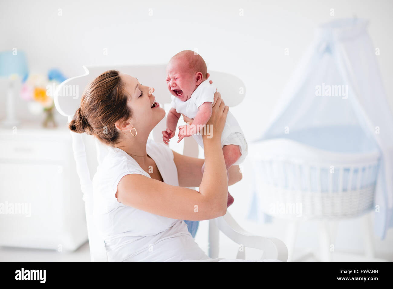 Young mother hugging her newborn child. Mom nursing baby. Woman and new