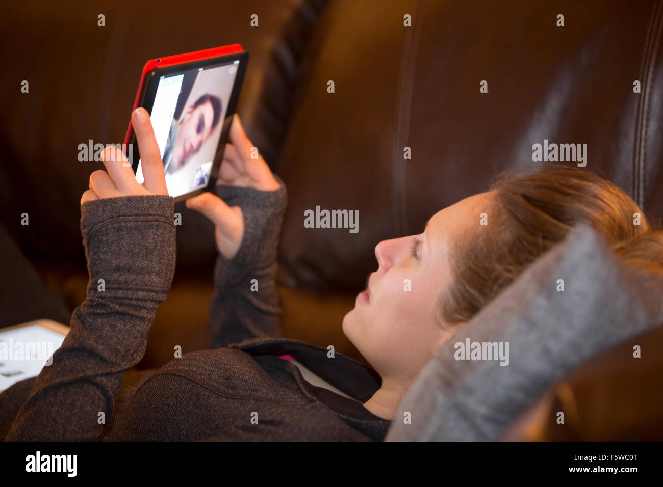 girl video chatting with boy on digital tablet computer Stock Photo