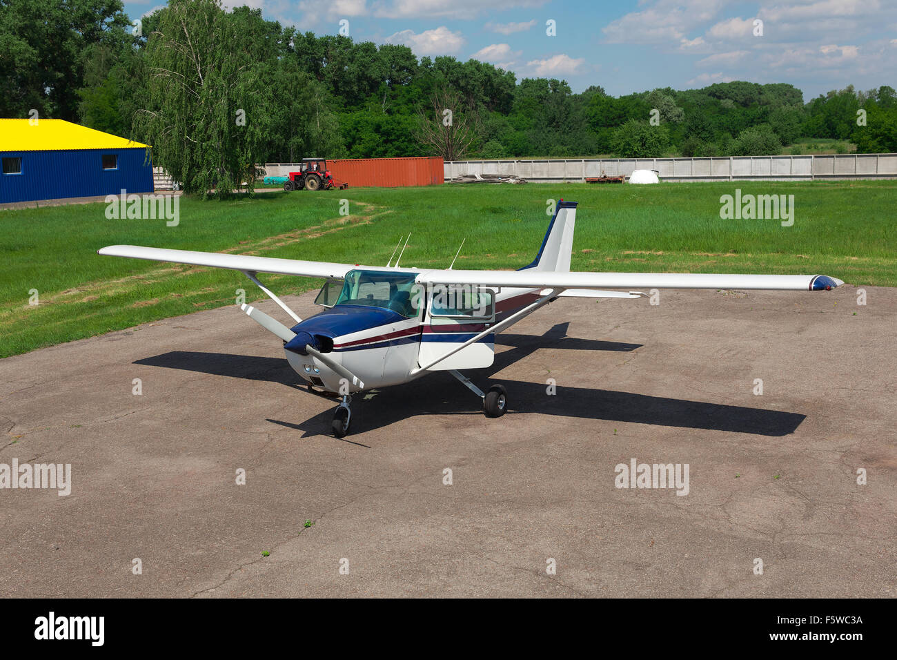 Small private plane parked on the airfield Stock Photo