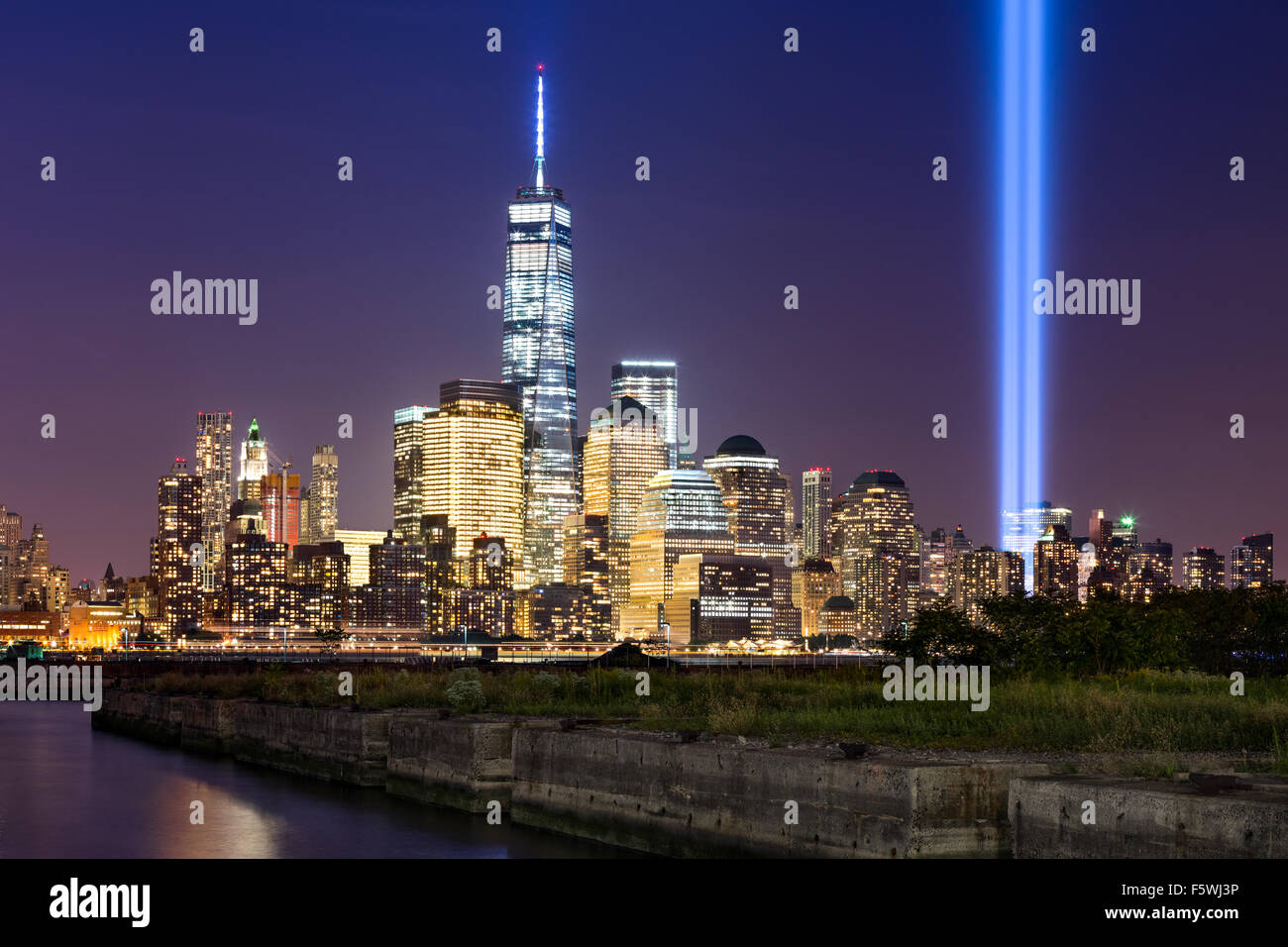 Tribute in Light, two vertical columns of light rise above Lower Manhattan adjacent to the new World Trade Center, New York City Stock Photo