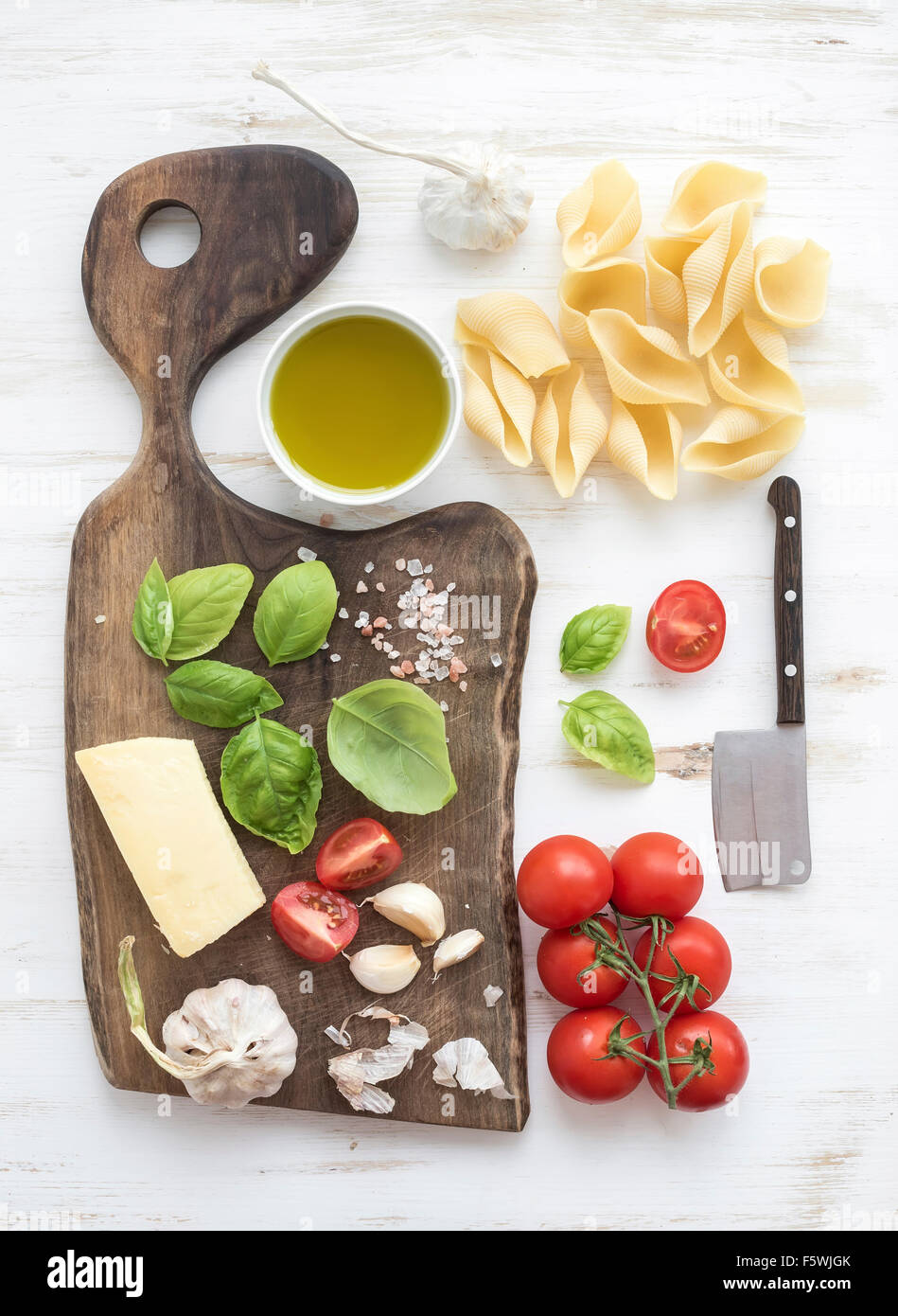 Ingredients for cooking pasta. Conchiglioni, basil leaves, cherry