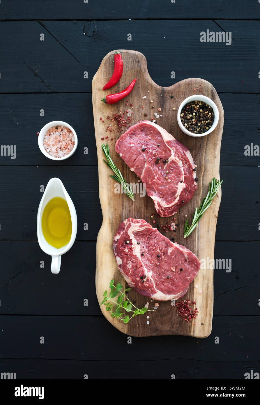 Raw fresh meat Ribeye steak entrecote and seasonings on cutting board