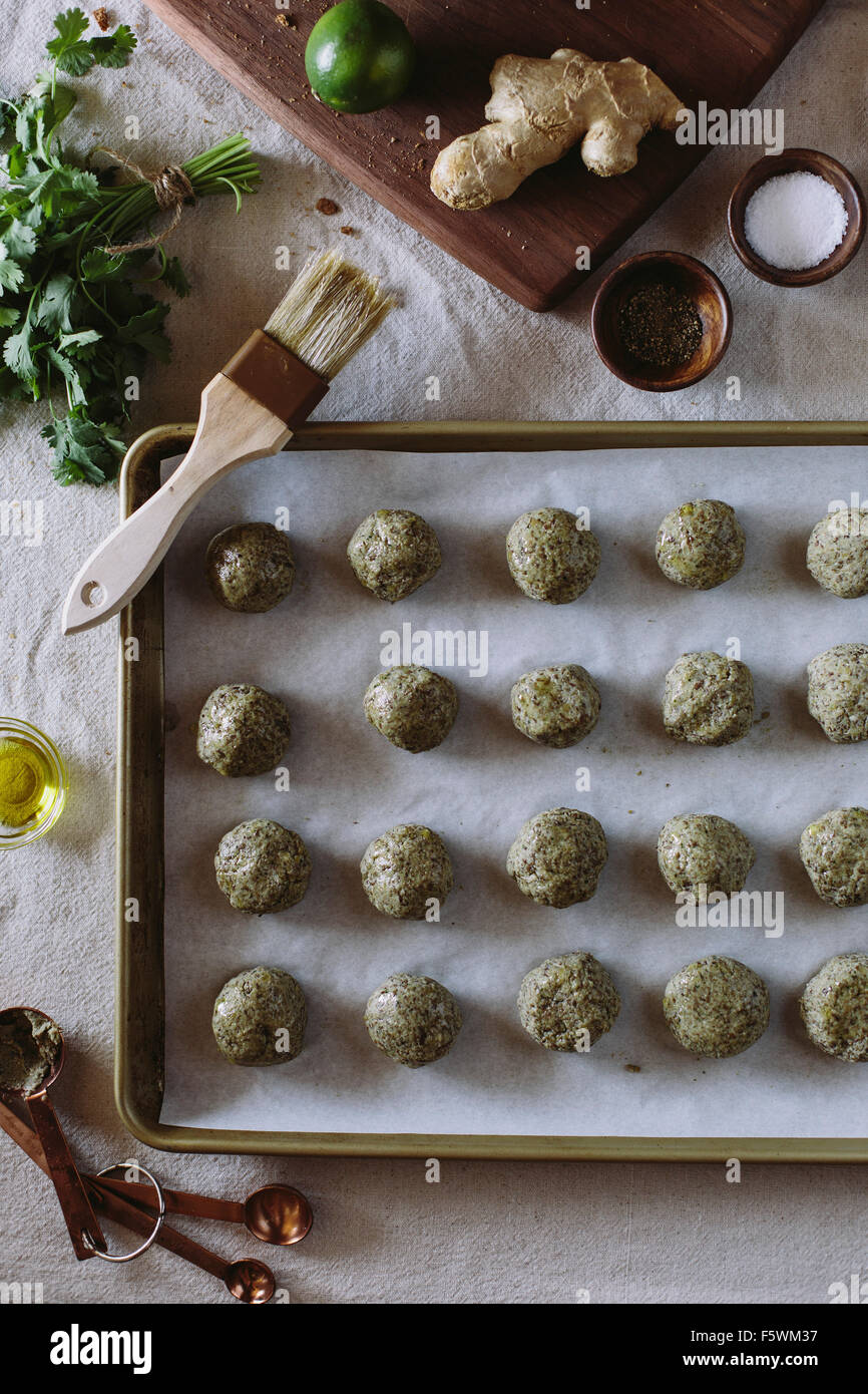 Curried Lentil Meatballs are displayed on a baking sheet before they