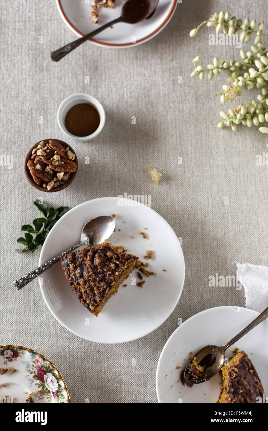 Two half eaten slices of Pumpkin Coffee Cake with Cocoa Vanilla Glaze are photographed from the top. Stock Photo