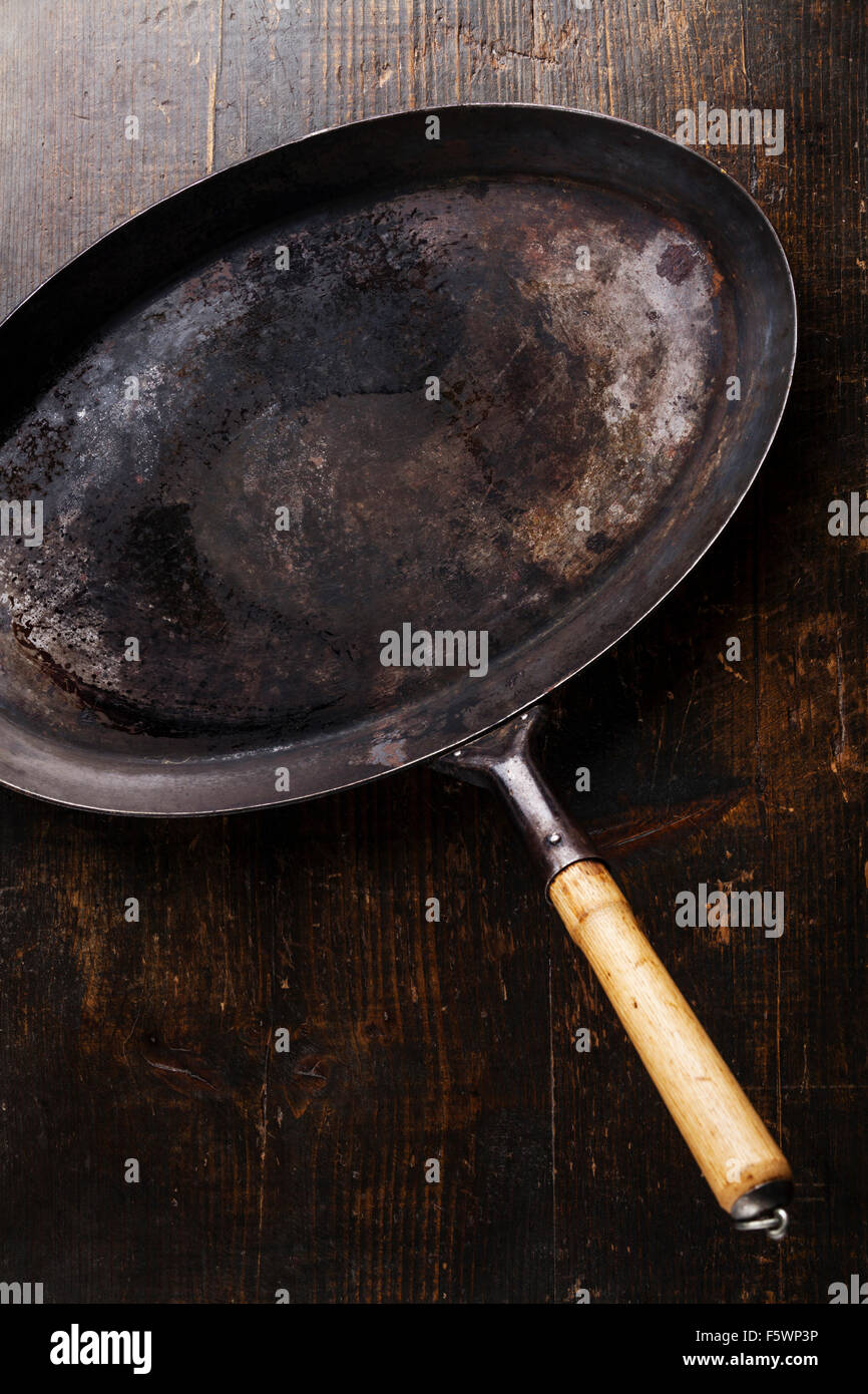 Vintage Kitchenware empty Pan Fish on dark wooden background Stock Photo