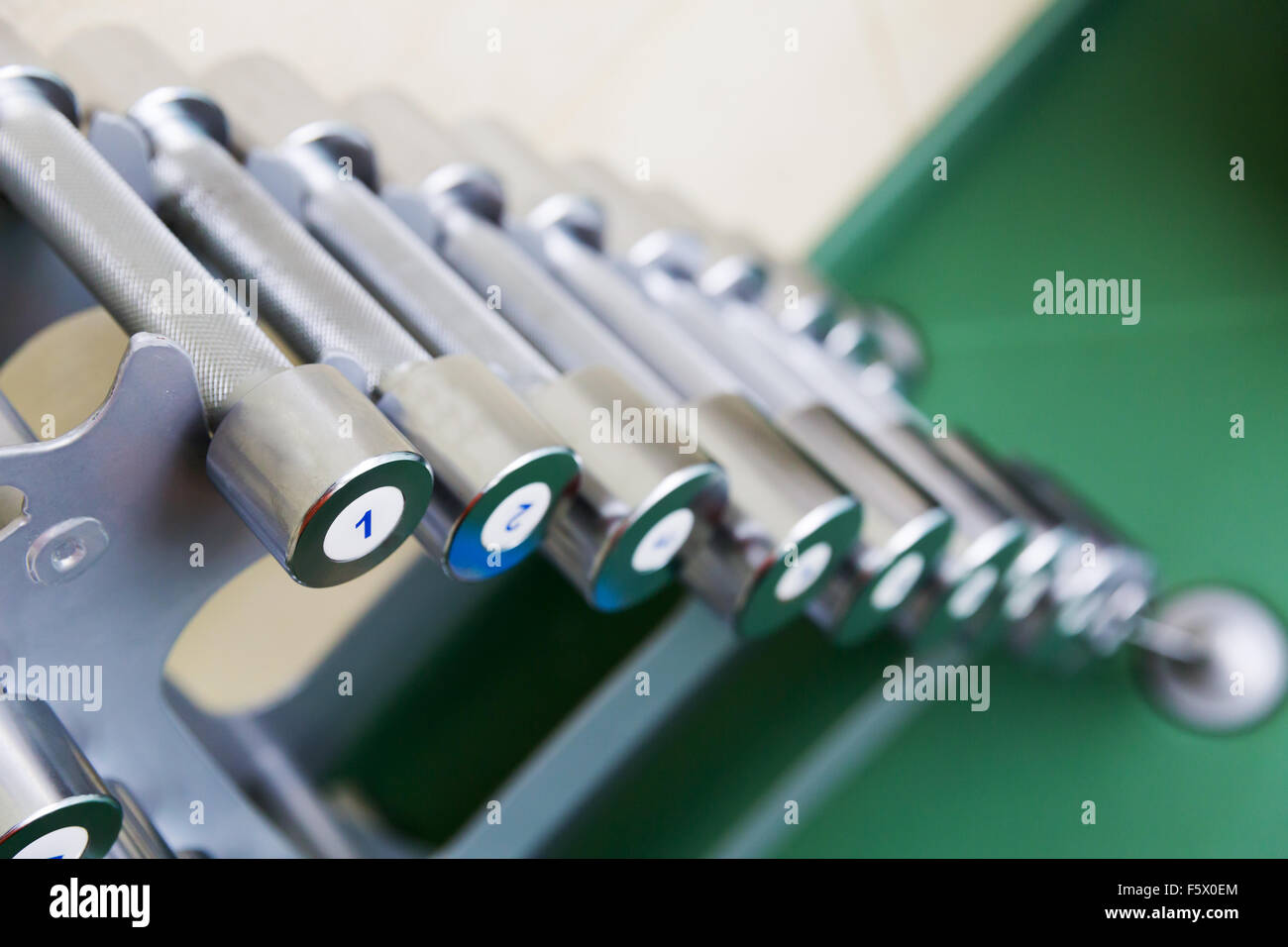 Dumb-bells on the stand closeup Stock Photo