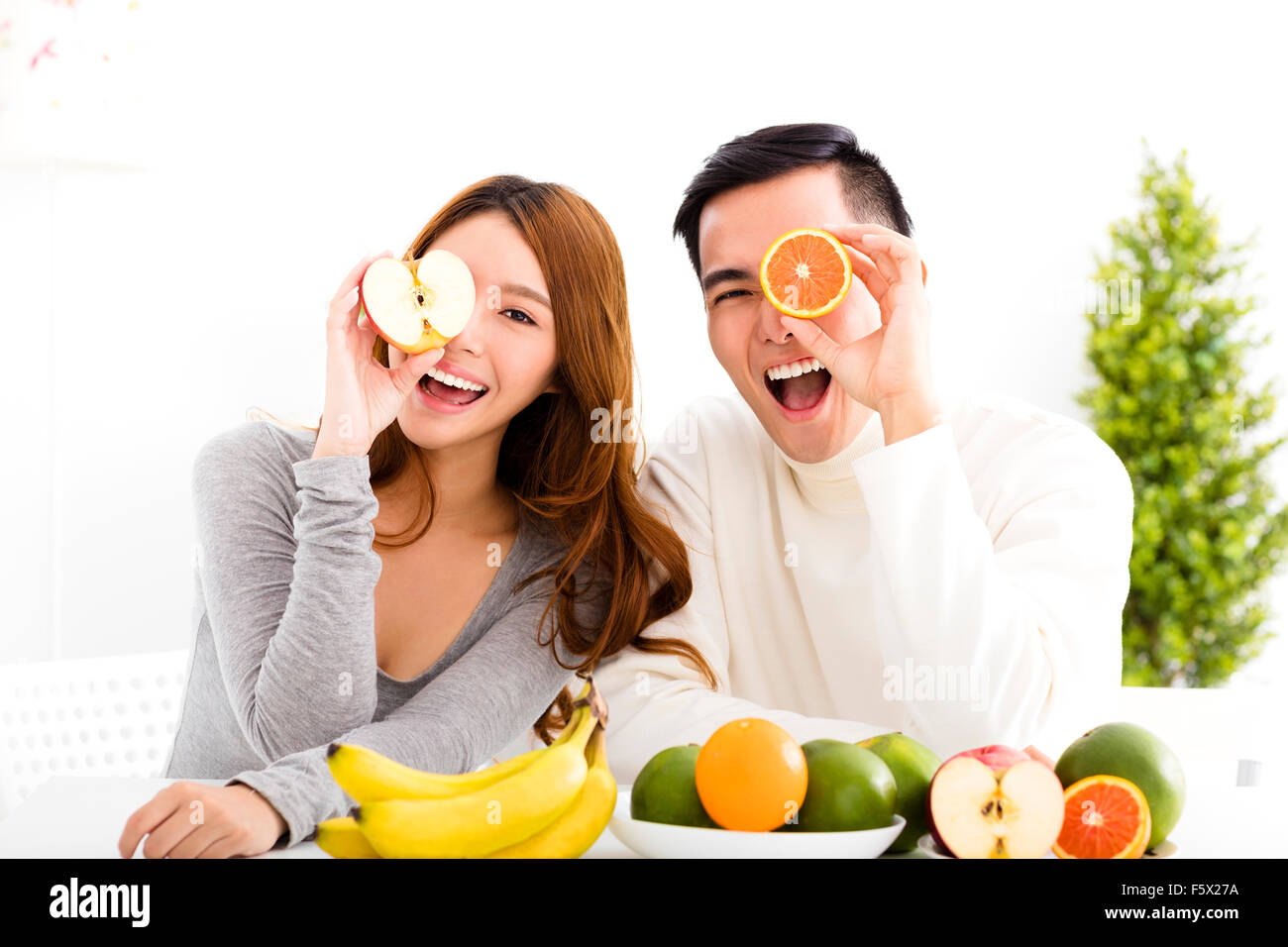 happy Young couple eating fruit and healthy food Stock Photo
