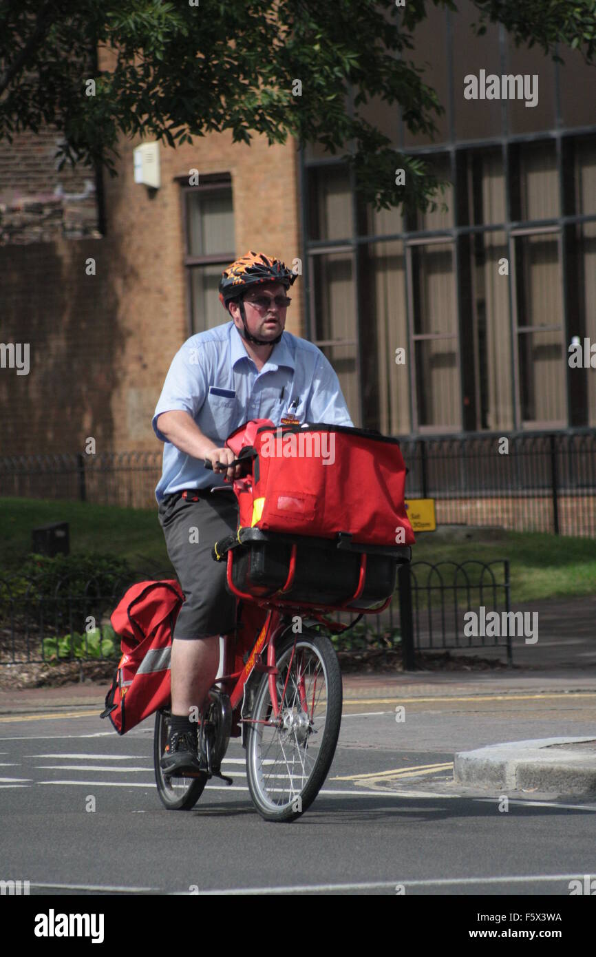Postman on his bike Stock Photo
