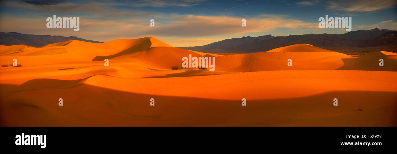 Panoramic scenic of shadows across sand dunes in low light of dawn in Death Valley, California Stock Photo