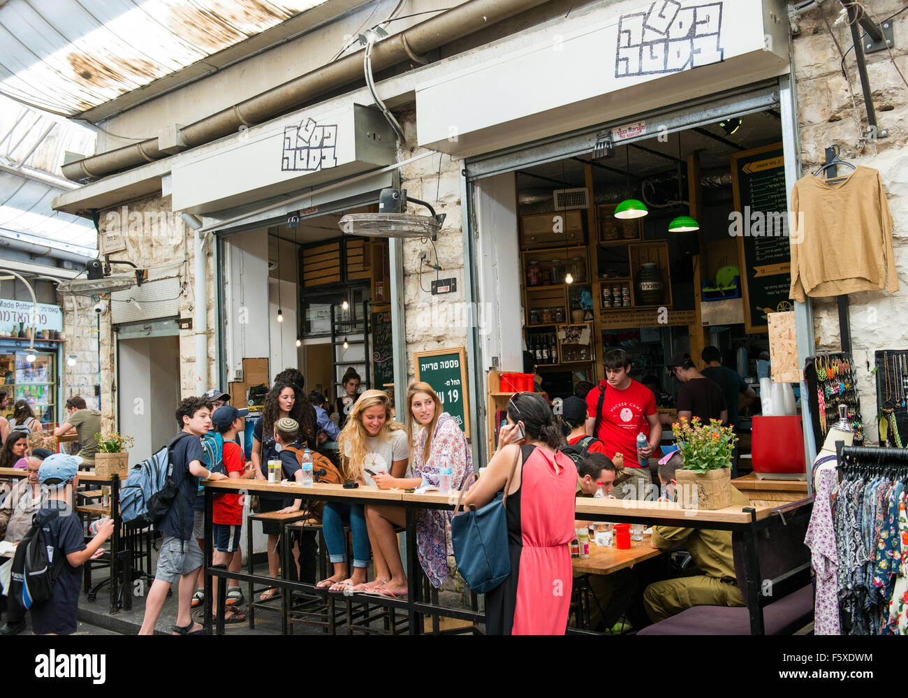 Young crowed sitting in popular restaurants and bars in the Machane Yehuda market in Jerusalem. Stock Photo