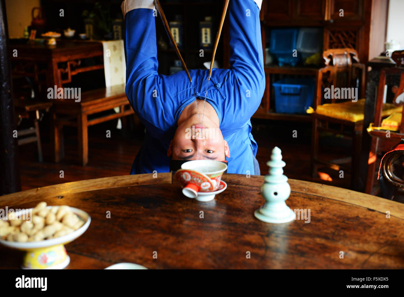 Pouring hot water for tea in a traditional acrobatic way. Stock Photo