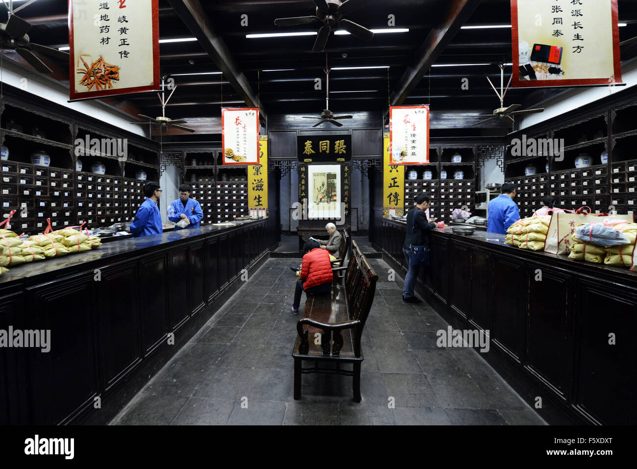 Pharmacist preparing herbal prescription at traditional Chinese medicine pharmacy in Hangzhou, China. Stock Photo