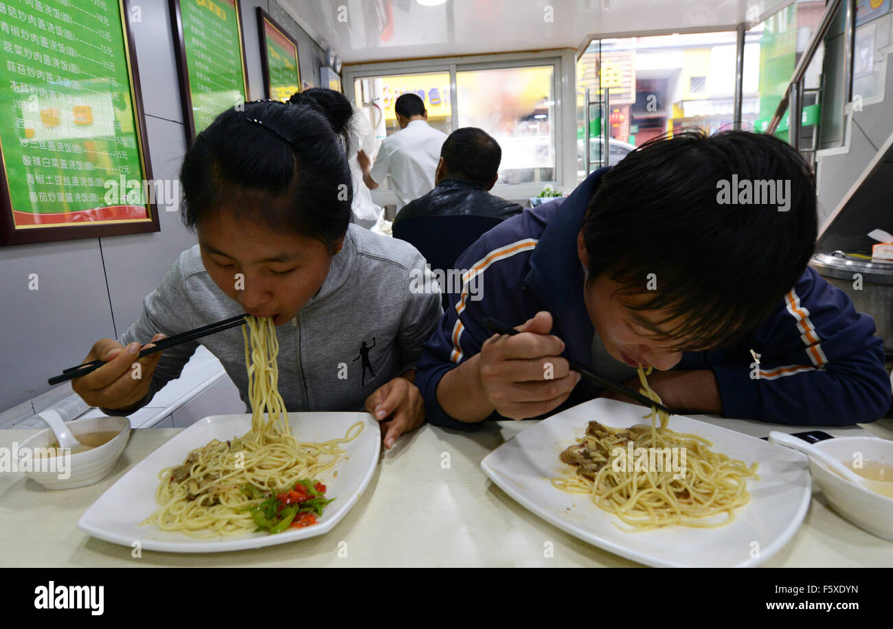 A Chinese couple enjoy Lanzhou style friend noodles. Stock Photo
