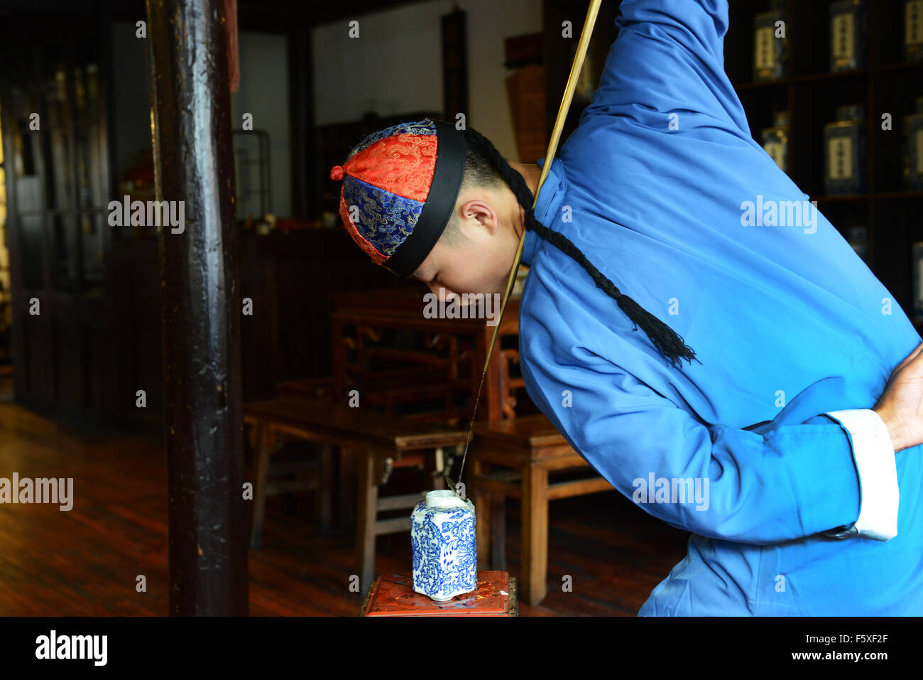 Pouring hot water for tea in a traditional acrobatic way Stock Photo