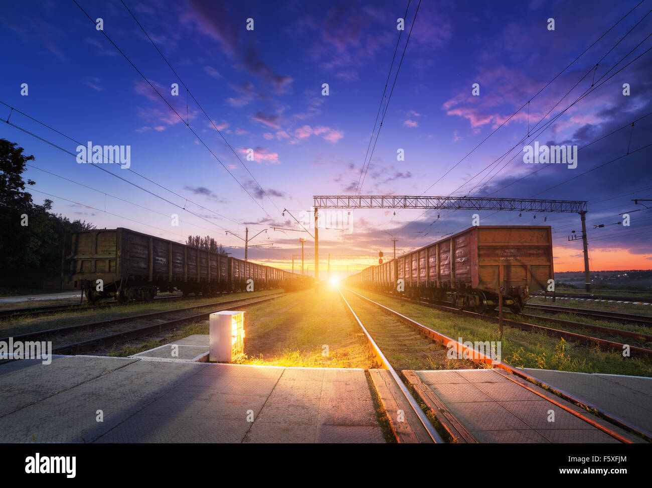 Cargo train platform at night. Railroad in Ukraine. Railway station. Stock Photo