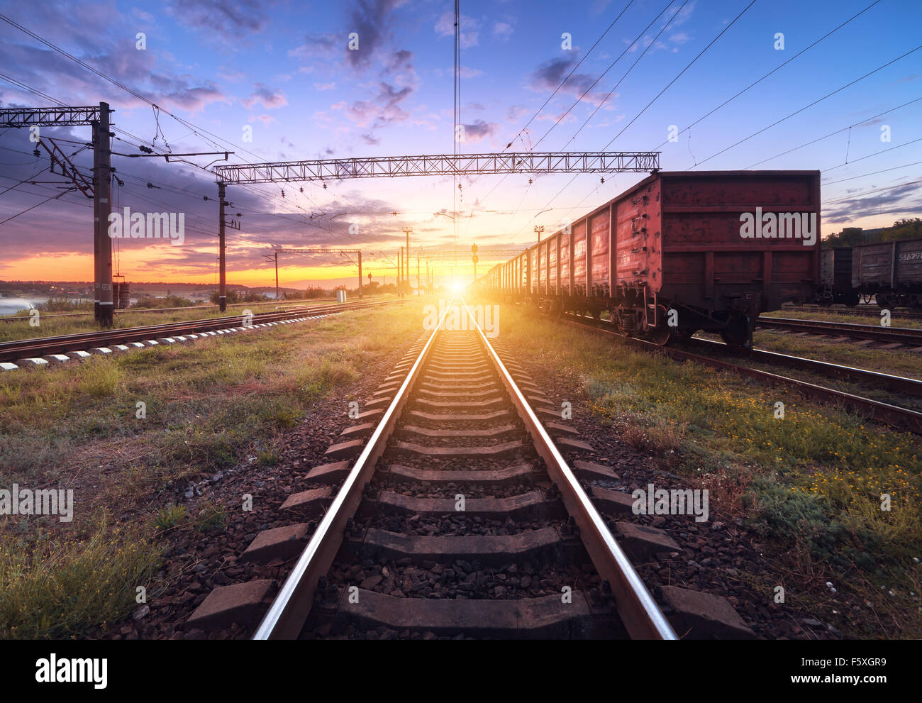 Cargo train platform at night. Railroad in Ukraine. Railway station. Stock Photo