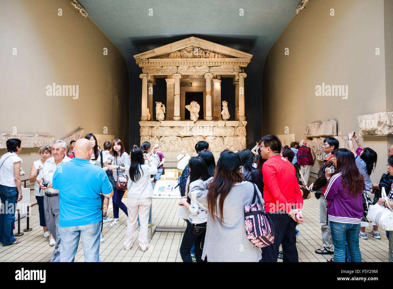 British Museum. The Greek Nereid Monument, from 380BC from Xanthos in hall busy with many people wandering around viewing displays. Stock Photo