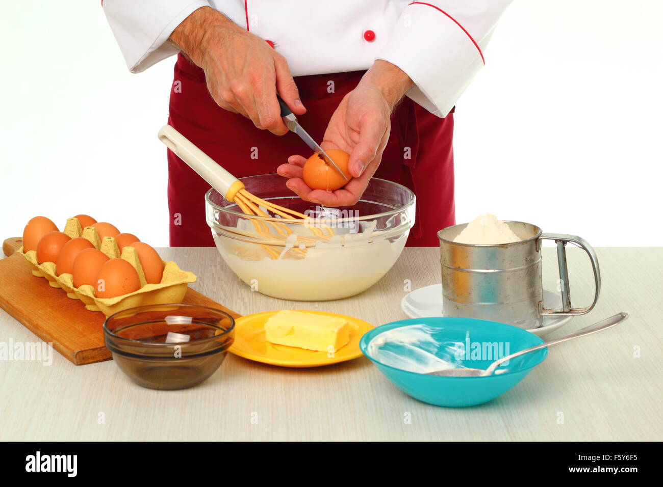 Cracking egg and adding into bowl. Making bundt cake with chocolate