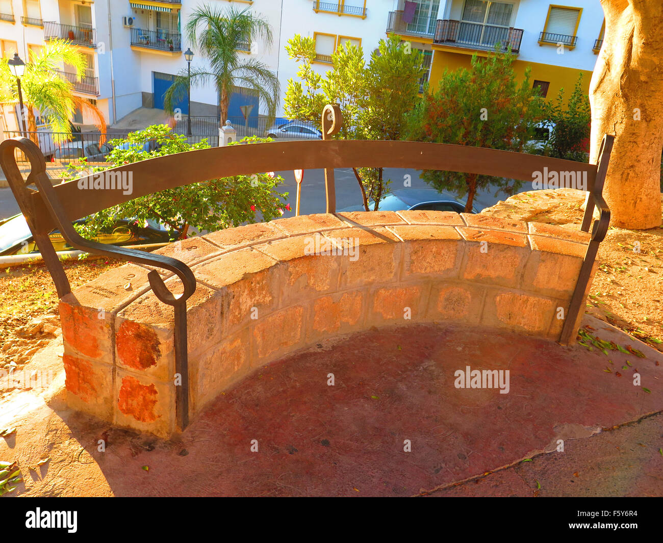 Semi circular brick built bench with iron arm and back rest in Alora Village, Andalucia Stock Photo