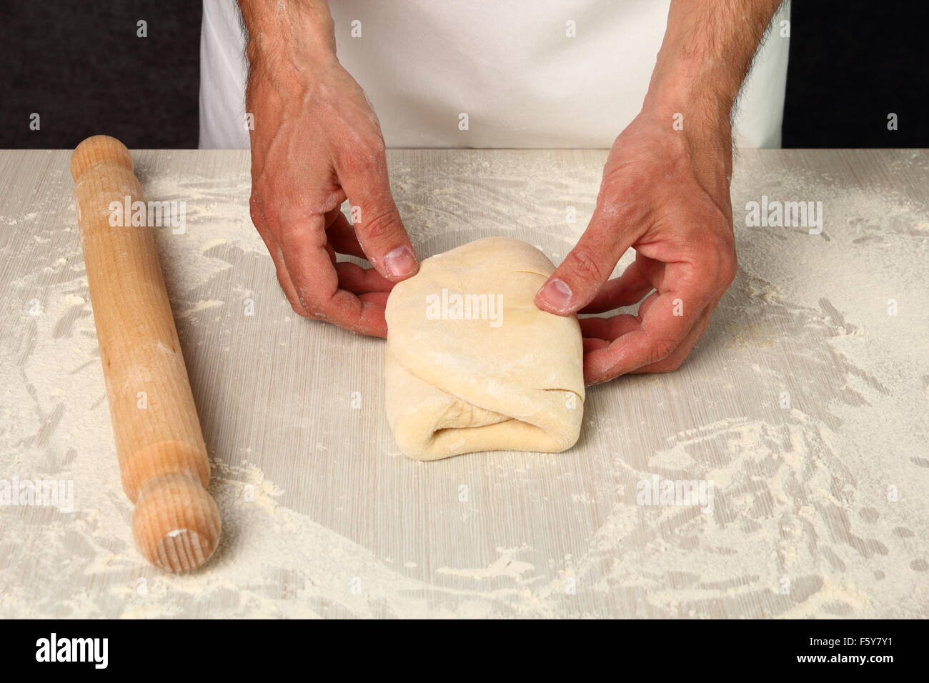 Making Puff Pastry. Folding lower third of dough over centre third and