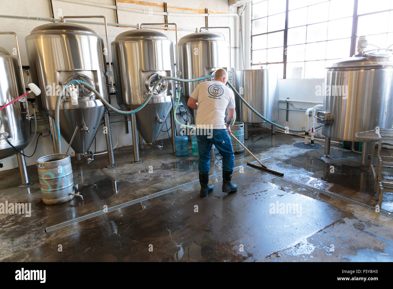 EUGENE, OR NOVEMBER 4, 2015 Brewery owner Brandon Woodruff cleaning the floor at the startup